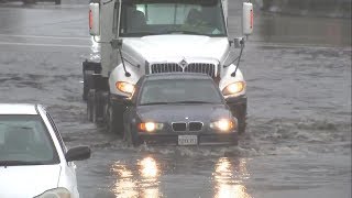 Big rig helps push car trapped in Oakland floodwaters [upl. by Samal460]